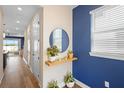 Bright foyer featuring wood-look floors and decorative accent wall at 10215 Park Estates Ave, Orlando, FL 32836