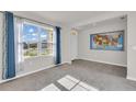 Living room with big windows, and an accent wall with map of the USA at 1068 Brooklet Dr, Davenport, FL 33837