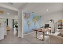 Bright office space features a large world map, desk, and comfortable seating at 1068 Brooklet Dr, Davenport, FL 33837