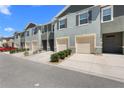 Well-maintained townhomes with attached garages, tidy landscaping, and a freshly paved street at 1121 Blue Jay Dr, Davenport, FL 33837