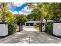 View of the home from gated driveway entrance at 120 W Trade Winds Rd, Winter Springs, FL 32708