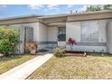 Charming front exterior featuring a well-manicured lawn and walkway leading to the front door at 1230 Westside Dr, Winter Garden, FL 34787