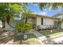 A cozy home featuring a cozy front yard with mature trees and a welcoming entrance at 1303 Azalea Way, Winter Garden, FL 34787