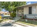 Single-story home featuring a cozy front yard with mature trees and a welcoming entrance at 1303 Azalea Way, Winter Garden, FL 34787