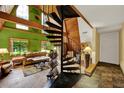Bright living room featuring vaulted wood ceilings, unique spiral staircase, and natural light at 14143 Conifer Dr, Orlando, FL 32832