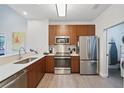 Well-equipped kitchen featuring stainless steel appliances, sleek cabinetry, and ample counter space for meal preparation at 14501 Grove Resort Ave # 2103, Winter Garden, FL 34787
