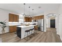 Modern kitchen with a center island, stainless steel appliances, and wooden cabinetry at 14673 Tanja King Blvd, Orlando, FL 32828