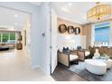 Flex room with modern decor, barrel-inspired wall art, and stylish seating area at 1938 Spring Shower Cir, Kissimmee, FL 34744