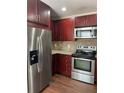 Kitchen featuring stainless steel appliances including a refrigerator, stove, oven, and microwave at 2164 Black Mangrove Dr, Orlando, FL 32828