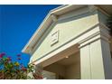 Close-up of the home's architectural detailing, highlighting the trim and the decorative emblem at 2458 Dream Home Ct, St Cloud, FL 34772