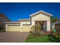 Charming single-story home with a paver driveway, well-manicured lawn, and lush landscaping leading to the front entrance at 2458 Dream Home Ct, St Cloud, FL 34772