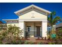 Quaint front porch showcases a rocking chair and decorative shrubbery creating a cozy and welcoming entry at 2458 Dream Home Ct, St Cloud, FL 34772