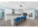 Eat-in kitchen with quartz counters, stainless appliances, subway tile backsplash, and island with bar seating at 2628 Cedar Shake Ct, Oviedo, FL 32765