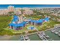 Expansive aerial view of waterfront condominiums with community pool, marina, and nearby beach at 2700 N Peninsula Ave # 215, New Smyrna Beach, FL 32169