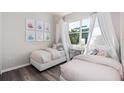Bright bedroom featuring two twin beds, a window view, and stylish decor at 2749 Serenity Meadow Dr, Kissimmee, FL 34744