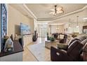 Bright and spacious living room with tile flooring, comfortable leather seating, and a view of the entryway at 3375 Bellino Blvd., New Smyrna Beach, FL 32168