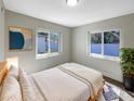 Cozy bedroom with natural light, neutral decor, and comfortable furnishings, perfect for relaxation at 370 E Waldo St, Groveland, FL 34736