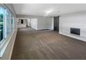 Open-concept living room features a fireplace, a modern sliding barn door, and seamless access to the kitchen at 370 E Waldo St, Groveland, FL 34736