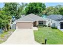 Lovely single-story home featuring a well-kept lawn, brick driveway, and convenient two-car garage at 3723 Broadway St, Gotha, FL 34734