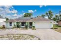 One-story home with a well-manicured lawn, circular driveway, and roof solar panels at 432 Taylorville St, Deltona, FL 32725