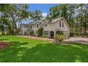 Inviting home featuring a manicured lawn, brick driveway leading to an attached garage at 450 Andrews Dr, Longwood, FL 32750