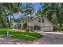 Beautifully landscaped home featuring a well-manicured lawn, brick driveway, and an attached garage at 450 Andrews Dr, Longwood, FL 32750