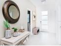 Inviting foyer with tiled floors, decorative mirror, and a welcoming ambiance at 4501 Target Blvd, Kissimmee, FL 34746