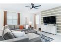 Cozy living room with sectional sofa, mounted TV, and stylish interior design at 4501 Target Blvd, Kissimmee, FL 34746
