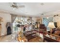 Cozy living room with a ceiling fan, curtains, and lots of musical instruments at 5547 Kingswood Dr, Orlando, FL 32810