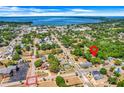 The aerial view captures the property's location within a quiet residential neighborhood near a large lake at 728 E Clifford Ave, Eustis, FL 32726