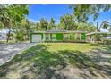 Charming single story home with a well-manicured lawn and an attached garage at 728 E Clifford Ave, Eustis, FL 32726