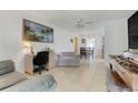 The living room features tile floors, a ceiling fan, and access to the dining area at 728 E Clifford Ave, Eustis, FL 32726