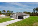 Angle shot of a modern white single-story home with black trim and a well-kept lawn at 741 Marion Oaks Ln, Ocala, FL 34473