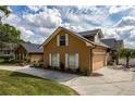 Image showcases the exterior, driveway, and partial front yard at 789 Errol Pkwy, Apopka, FL 32712