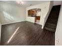 Inviting living area with wood floors, adjacent to a kitchen, and staircase to upstairs at 8271 Maritime Flag St # 125, Windermere, FL 34786