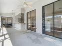 Covered patio with a ceiling fan, exterior windows, sliding glass doors, and a view of the backyard and pool area at 118 White Birch Dr, Kissimmee, FL 34743