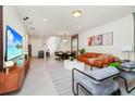Open-concept living space with modern decor, seamlessly blending living and dining areas at 1293 Emerald Row, Clermont, FL 34714