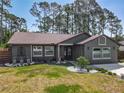 Charming home featuring a landscaped front yard with decorative stone and lush green grass at 1296 Gage Ave, Deltona, FL 32738