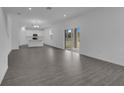 Open floor plan with gray wood-look flooring, and a view of the kitchen at 1343 Wood Line Dr, Deland, FL 32720