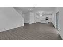 Spacious living room featuring open floor plan and gray wood-look flooring at 1343 Wood Line Dr, Deland, FL 32720