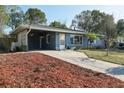 Charming single-story home with a well-manicured lawn, blue paint, and a cozy front porch at 1656 Brentlawn St, Deltona, FL 32725
