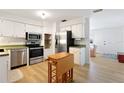 Well-lit kitchen with stainless steel appliances and convenient moveable island at 1656 Brentlawn St, Deltona, FL 32725