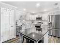 Bright kitchen featuring white cabinets, stainless steel appliances, and central island at 2817 Prince John Rd, Winter Park, FL 32792