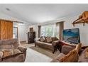 Cozy living room featuring a large window, comfortable seating, and vintage decor at 3218 Cimarron Dr, Orlando, FL 32829