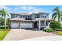 Attractive two-story home featuring a three-car garage, brick driveway, and lush front lawn at 3417 Michigan St, Lake Mary, FL 32746