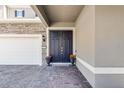 Inviting front entrance with a double door, brick paved porch, and attractive exterior lighting at 3417 Michigan St, Lake Mary, FL 32746