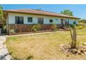 Attractive single-story home with light-colored siding, brick foundation details, and a well-kept lawn at 3975 Rambler Ave, St Cloud, FL 34772