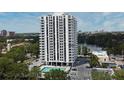 Modern condo building featuring a swimming pool and ample parking at 400 E Colonial Dr # 1003, Orlando, FL 32803