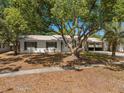 Charming single-story home featuring lush mature trees and a metal roof at 5326 Weirwood Ave, Orlando, FL 32810