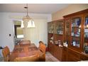 Dining room featuring a wooden table, chairs, and a glass-front display cabinet at 5502 Minaret Ct, Orlando, FL 32821